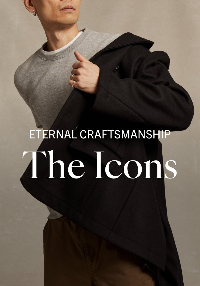 Person wearing a black coat over a gray sweater with 'Eternal Craftsmanship: The Icons' text.