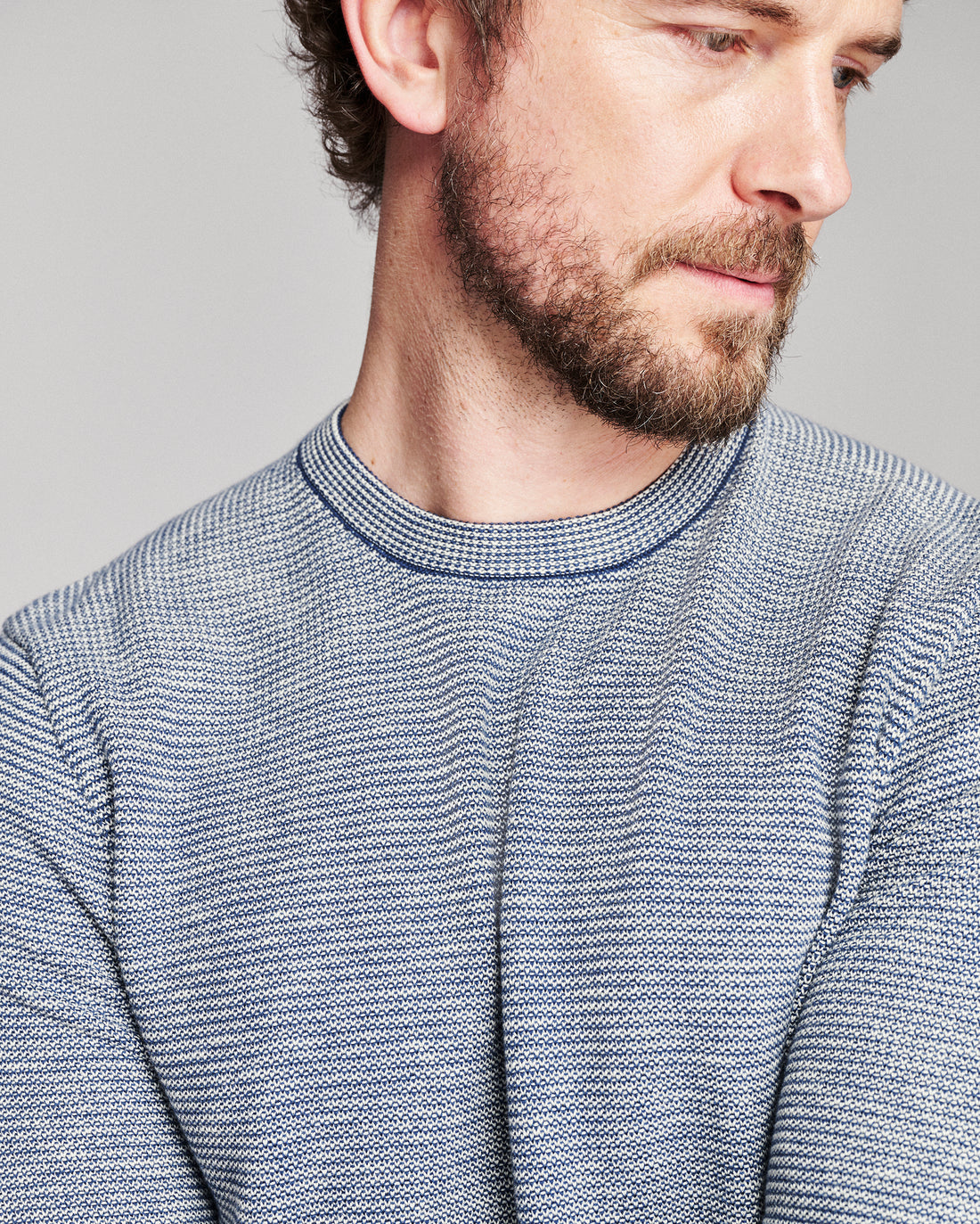 blue striped sweater worn by a brown haired model