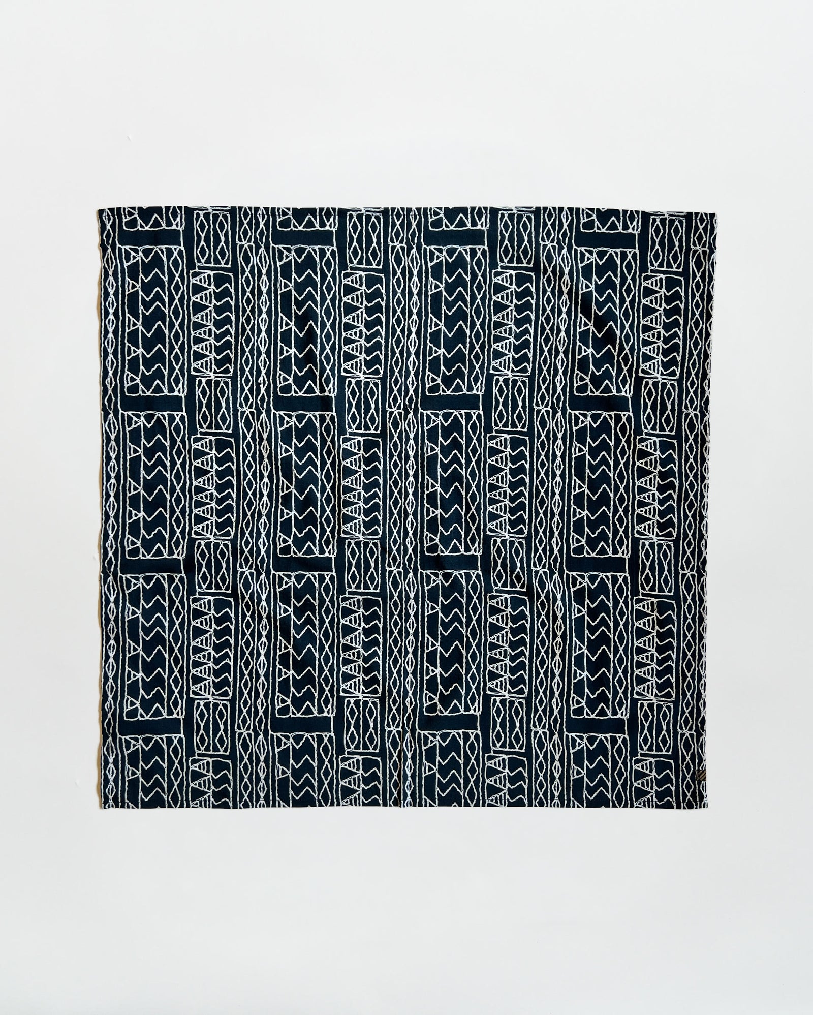 Black and white patterned fabric on a light gray background
