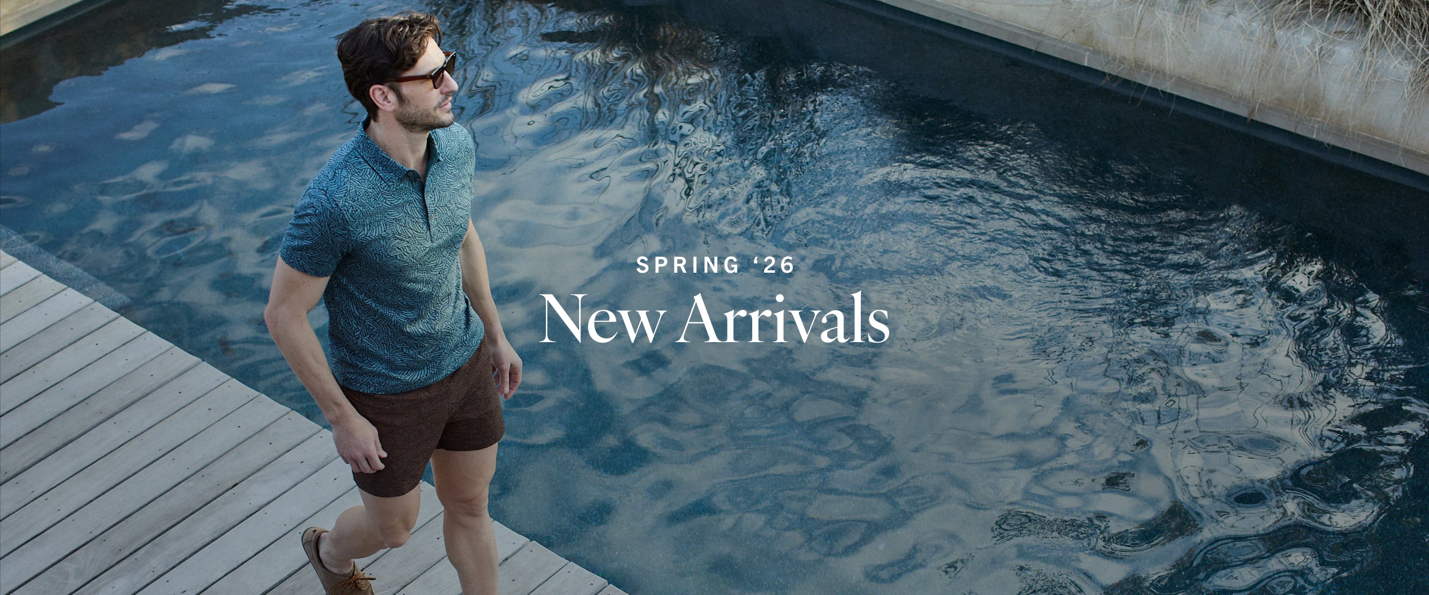 Man walking by a pool with 'Spring '26 New Arrivals' text overlay