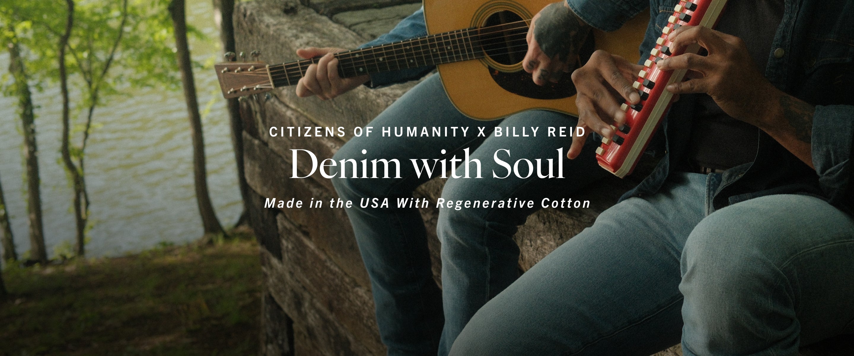Person playing guitar with denim jeans, featuring 'Citizens of Humanity x Billy Reid' branding.