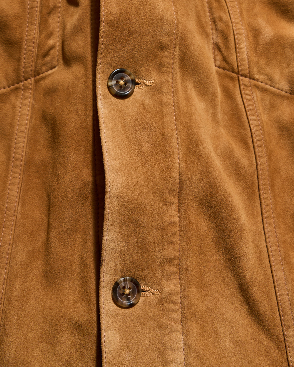Close-up of a brown suede jacket with buttons