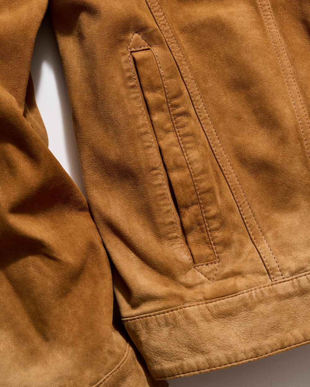 Close-up of a brown jacket with a pocket on a white background