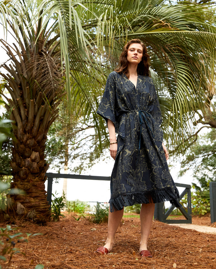 The model wears the Juniper Jacquard Kaftan in Carbon Blue/Olive