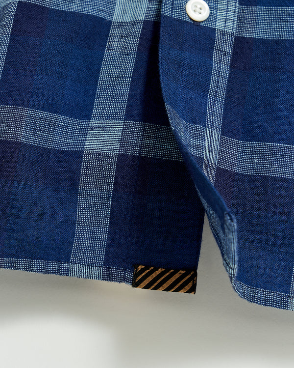 Tuscumbia Shirt Button Down in Indigo | Shows the heirloom ribbon tab at the bottom hem of the shirt.
