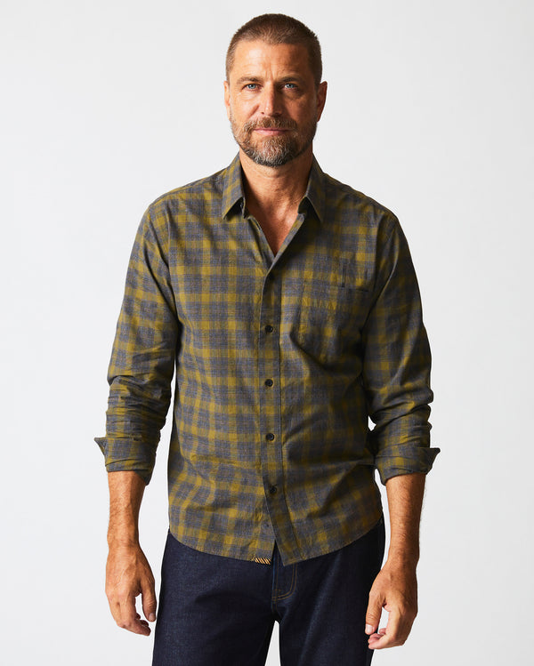 Male model wears the Melange Shadow Plaid Tuscumbia Shirt in Grey/Olive