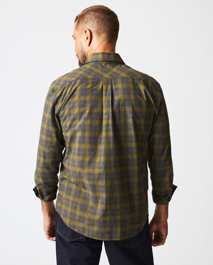 Male model wears the Melange Shadow Plaid Tuscumbia Shirt in Grey/Olive