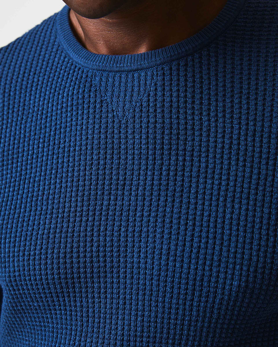 Male model wears the Mini Waffle Crew in Denim Blue