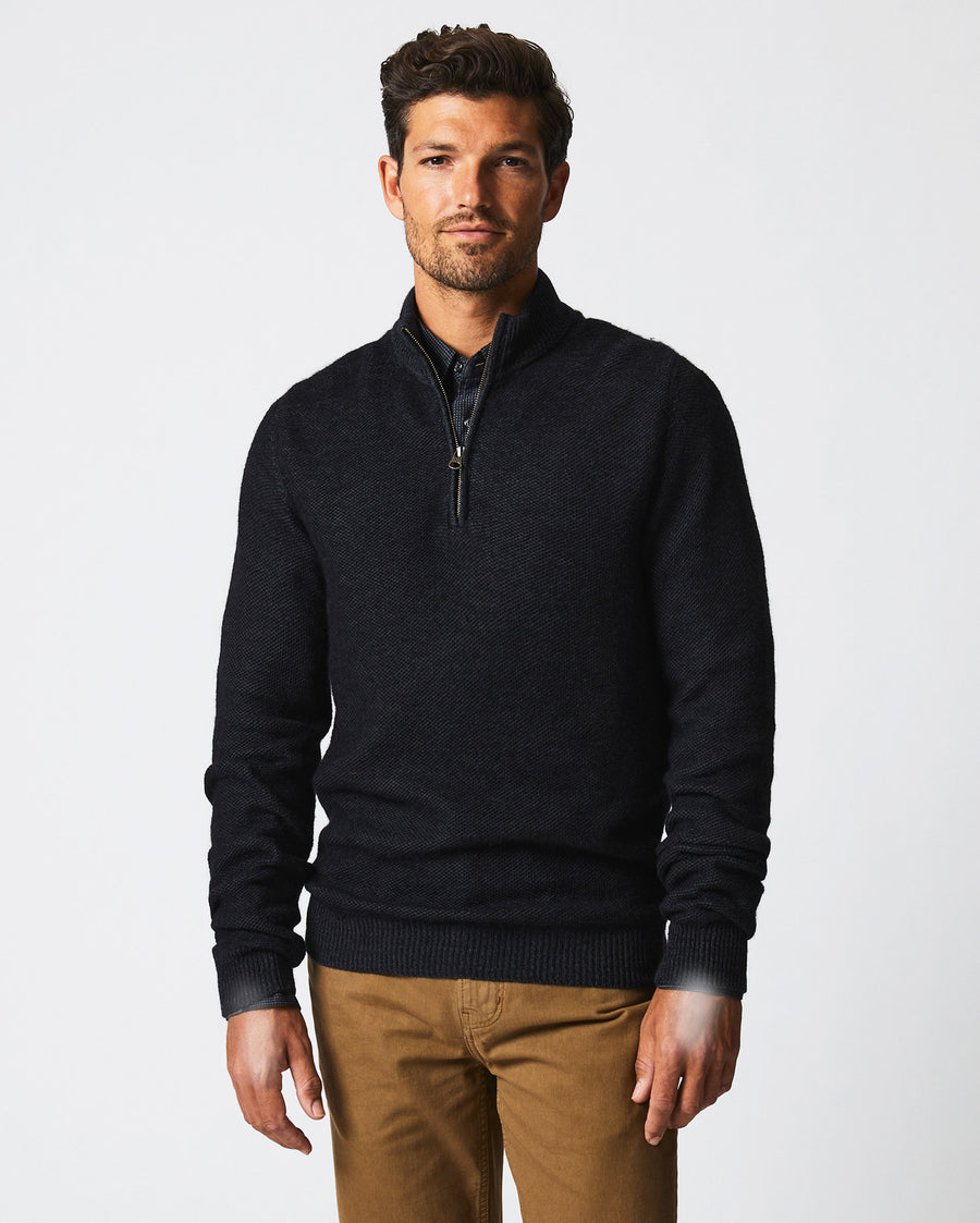 Male model wears the Merino Half Zip in Black