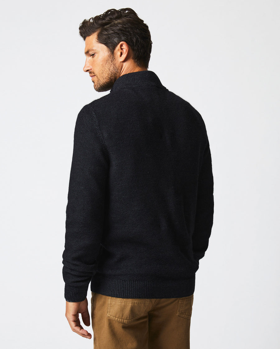 Male model wears the Merino Half Zip in Black