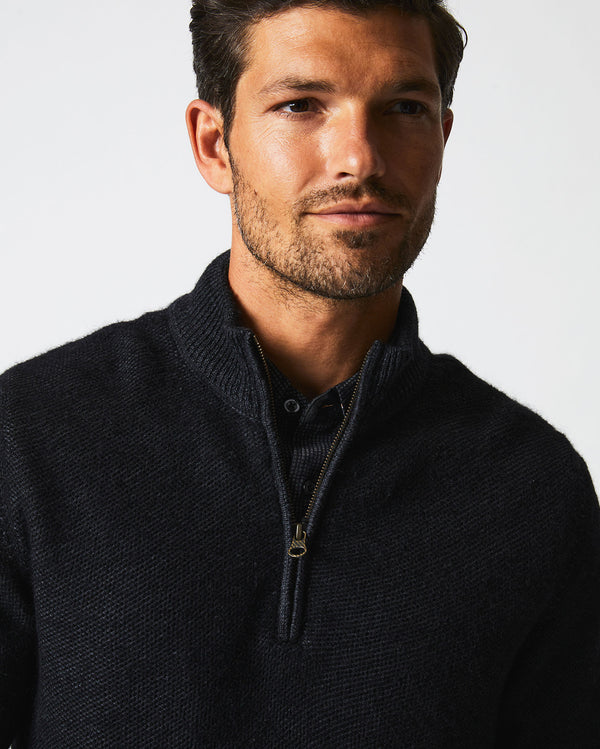 Male model wears the Merino Half Zip in Black