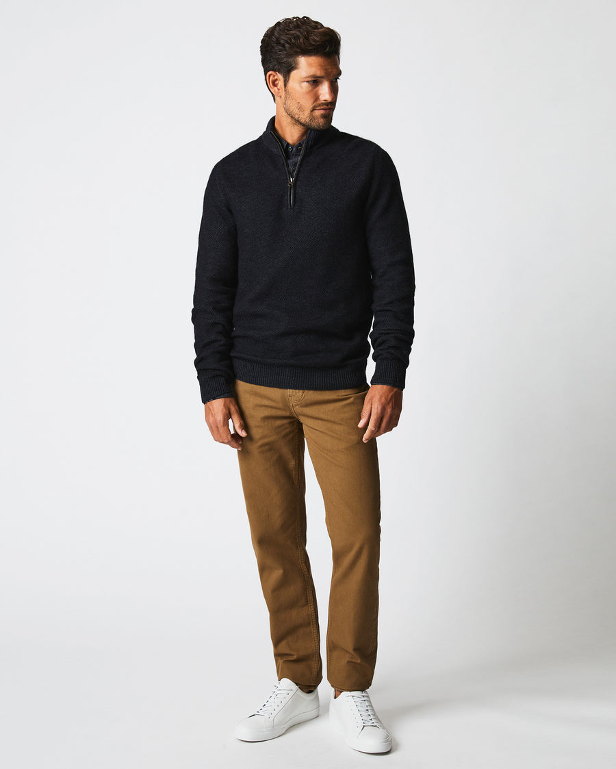 Male model wears the Merino Half Zip in Black