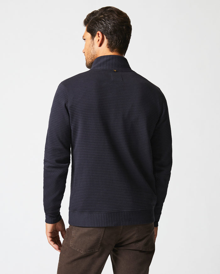 Male model wears the Quilted Half Zip in Dark Navy