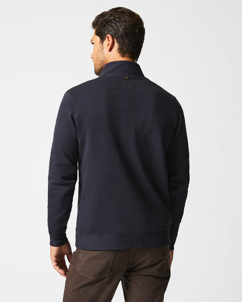 Male model wears the Quilted Half Zip in Dark Navy