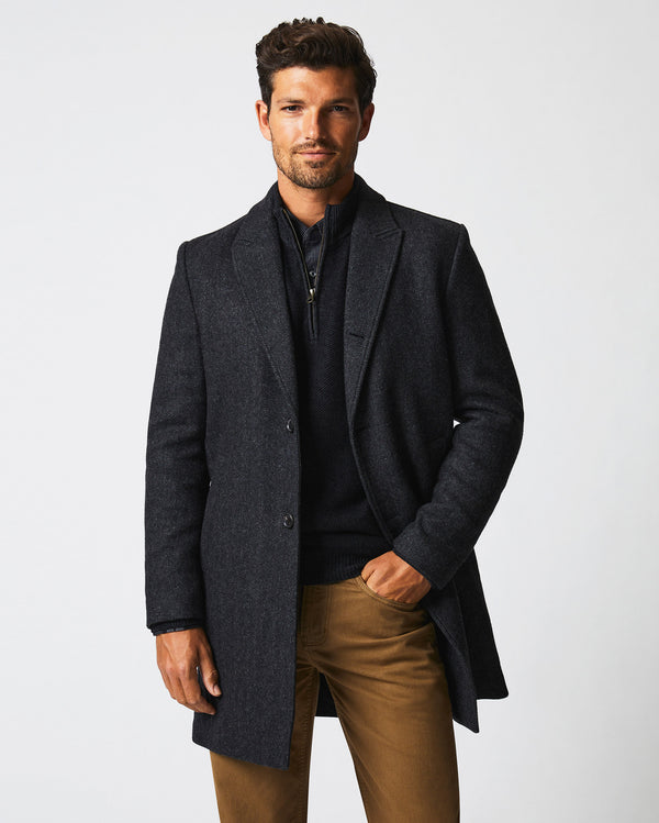 Male model wears the Walking Car Coat in Charcoal