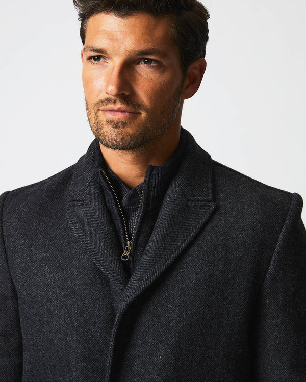 Male model wears the Walking Car Coat in Charcoal