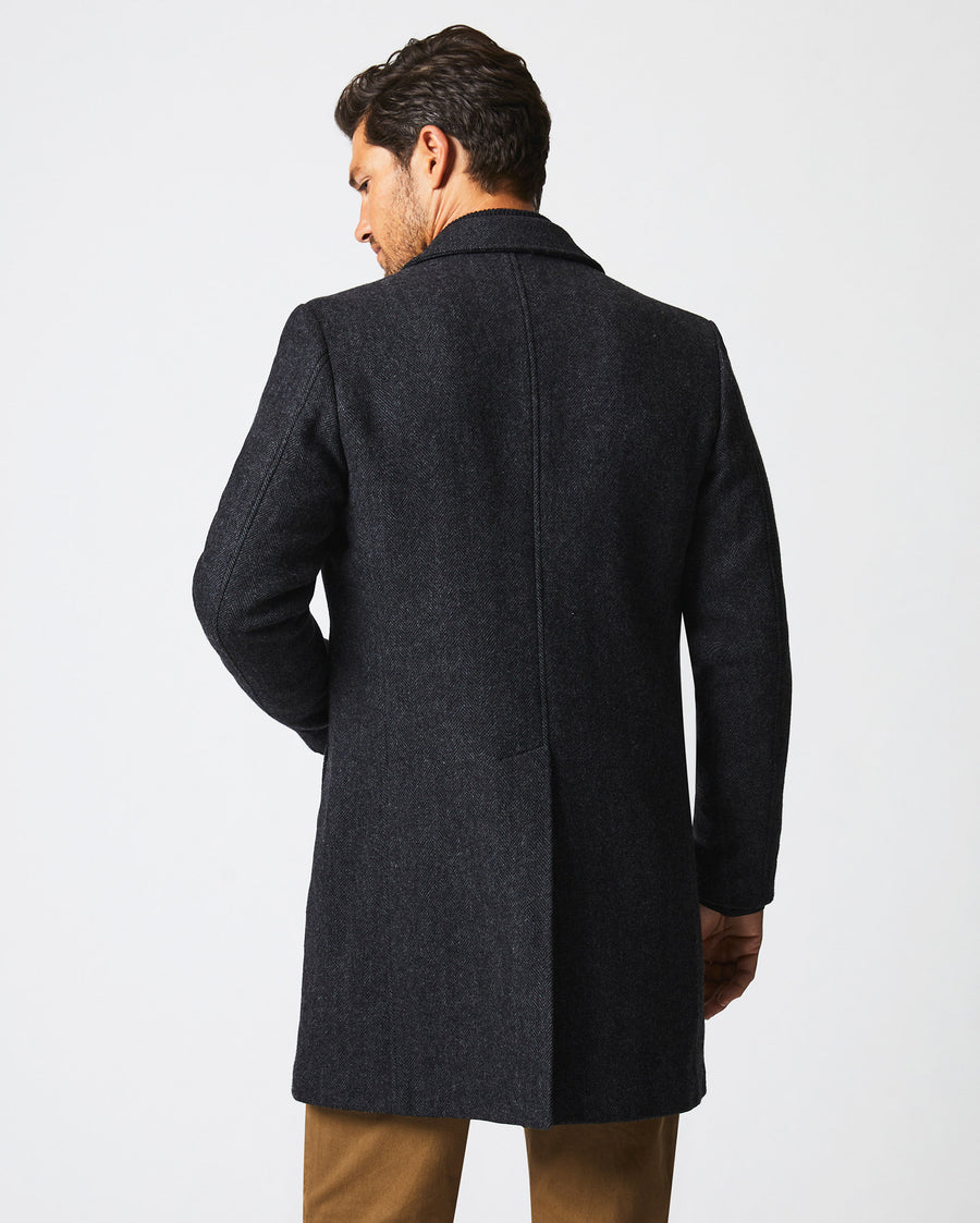 Male model wears the Walking Car Coat in Charcoal