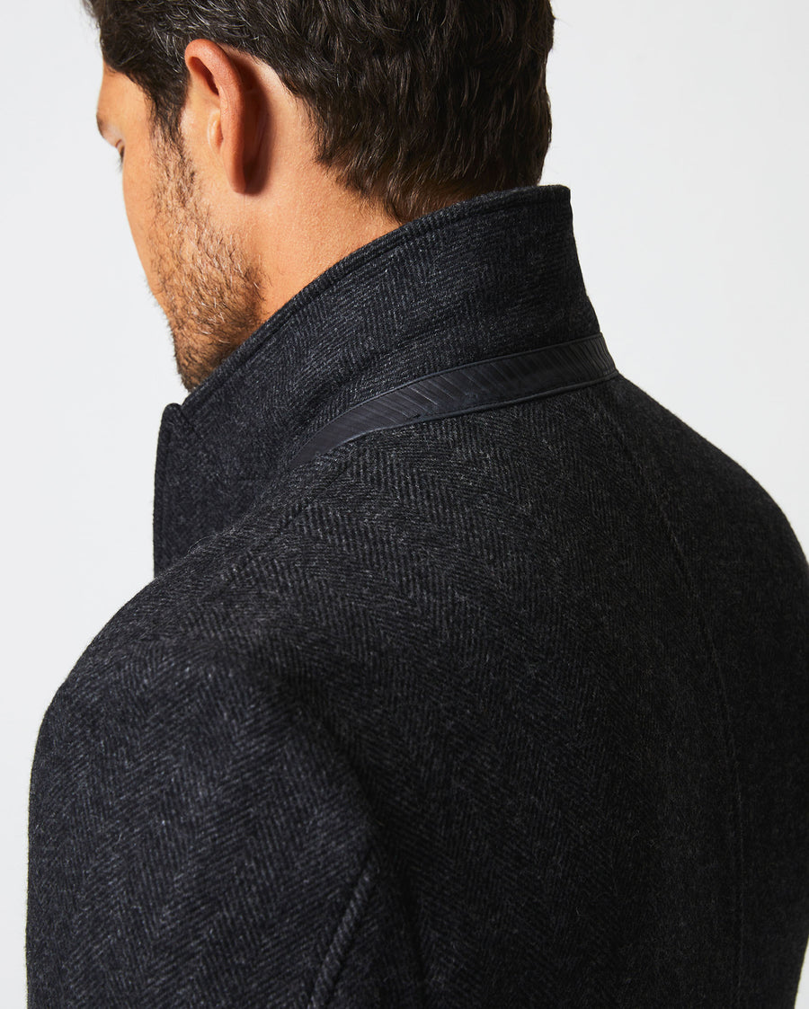 Male model wears the Walking Car Coat in Charcoal