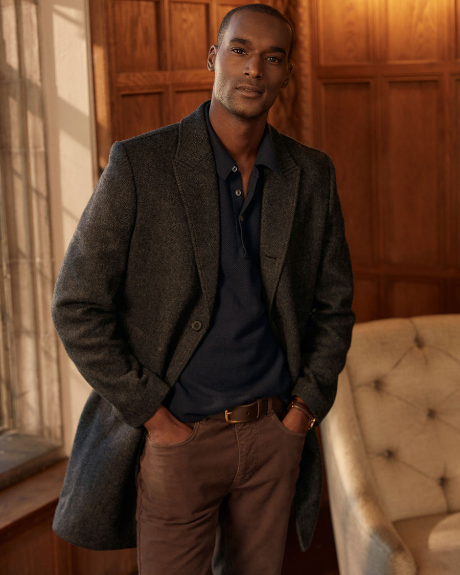 Male model wears the Walking Car Coat in Charcoal