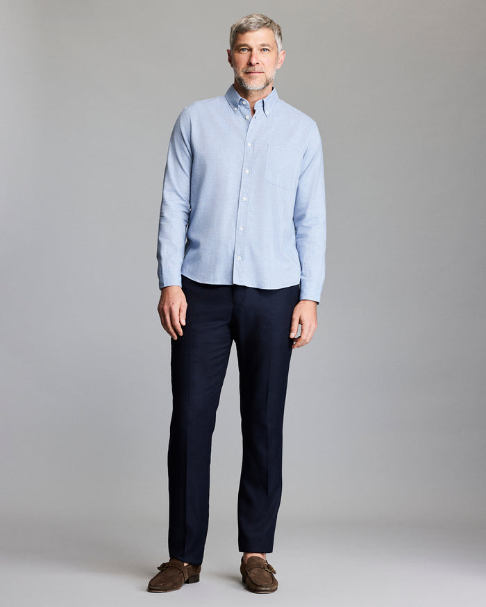 Model wears the light blue button up shirt.