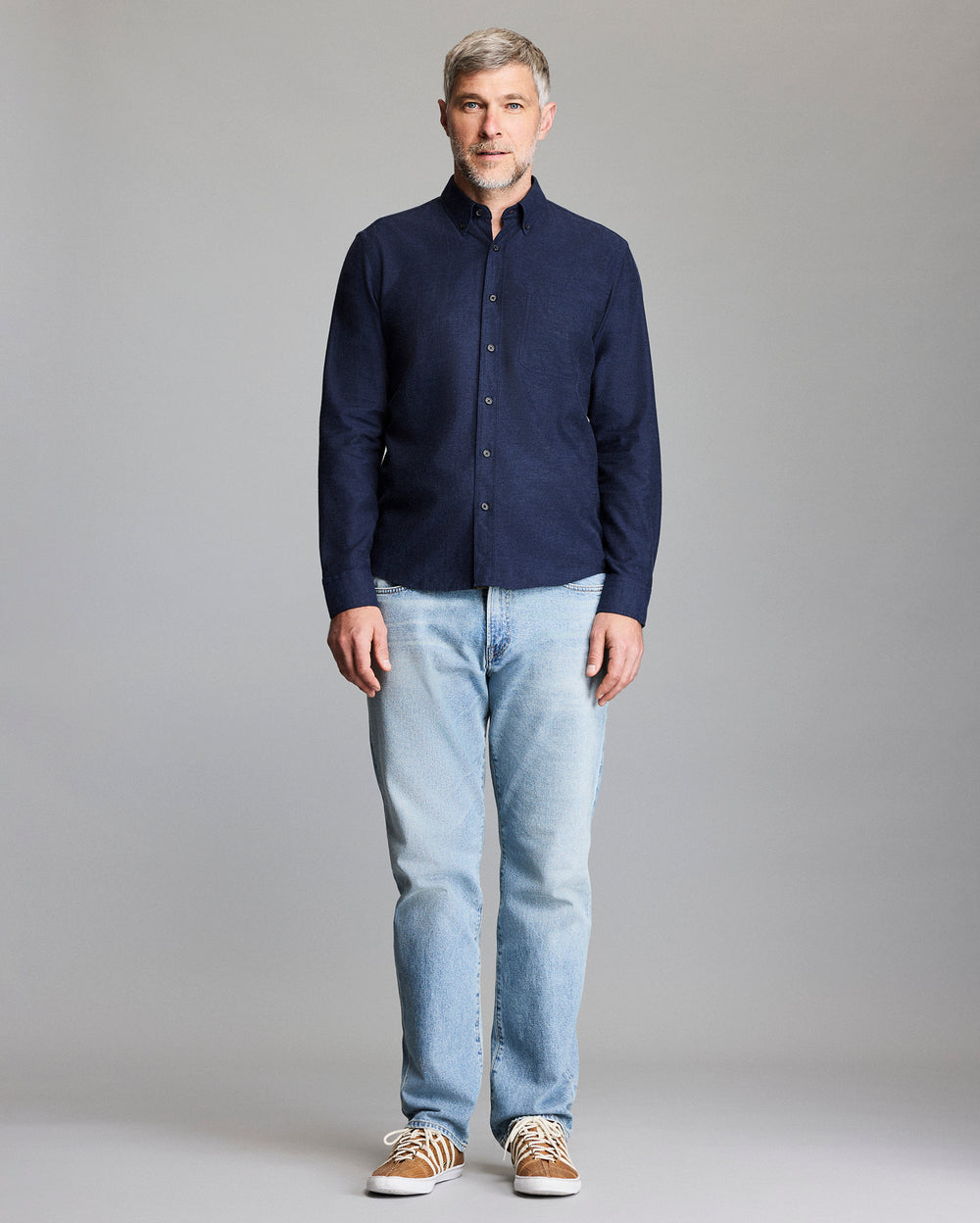 Model wears the navy button down shirt.