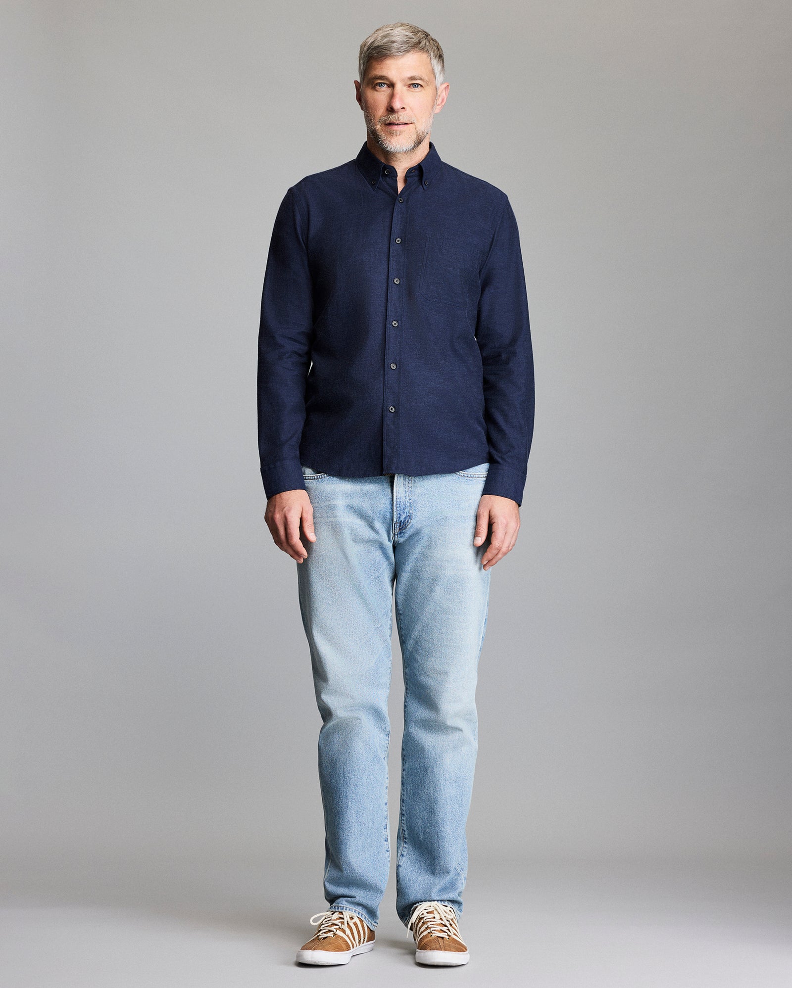 Model wears the navy button down shirt.