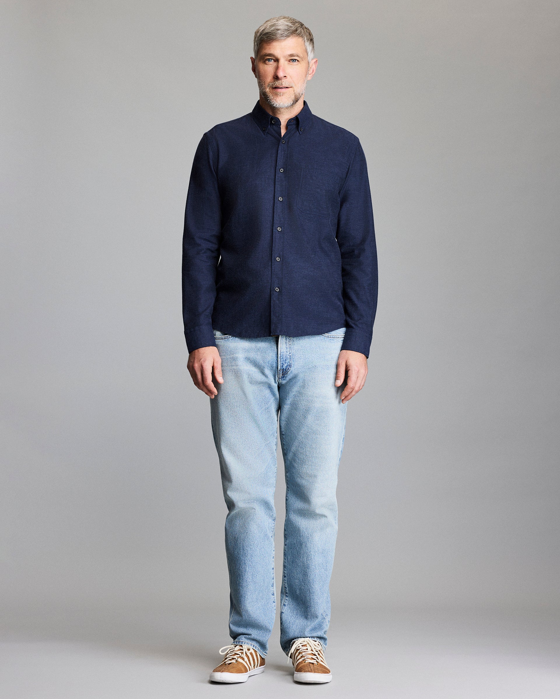 Model wears the navy button down shirt.