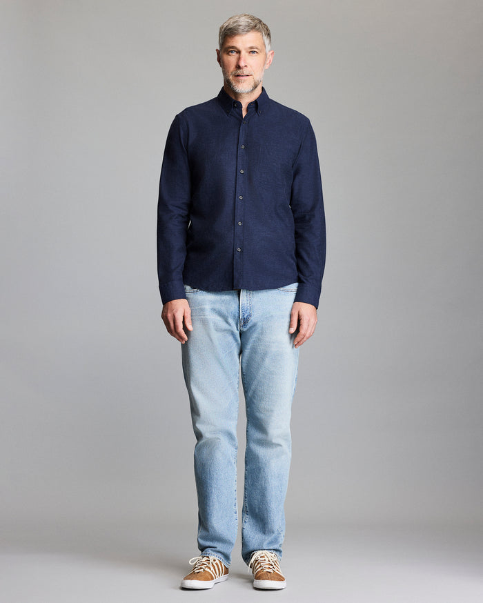 Model wears the navy button down shirt.