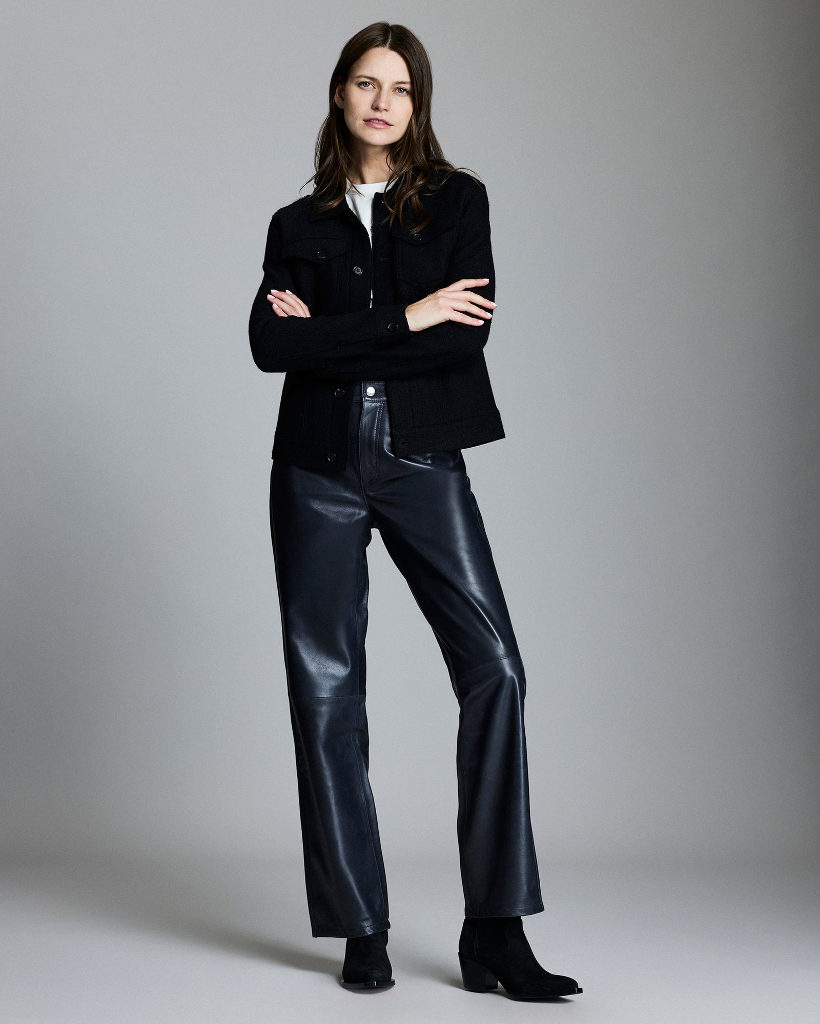 Model shows the fit of the jacket, her arms are crossed and she is smiling.