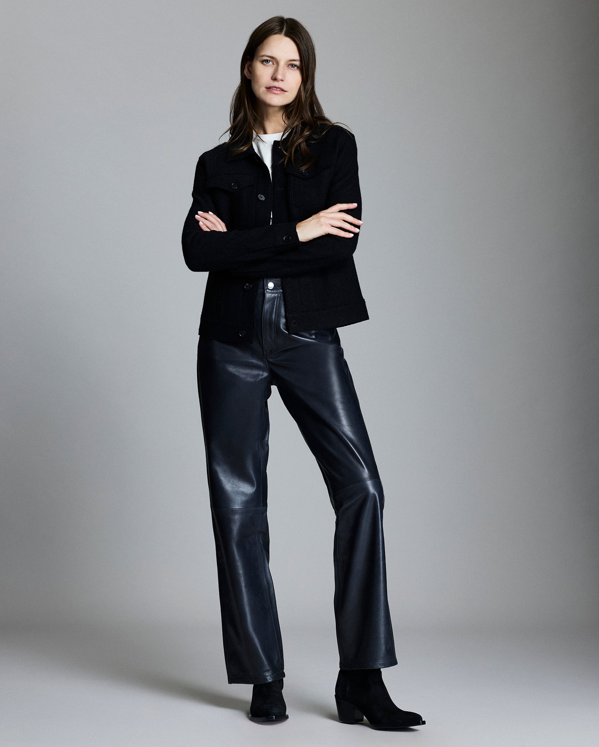 Model shows the fit of the jacket, her arms are crossed and she is smiling.