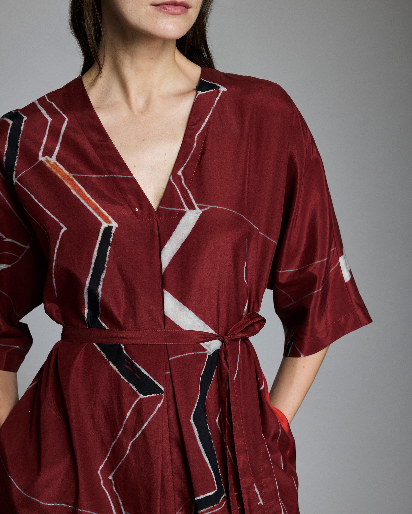 Close up of the dress, showing the tie belt and mountain-inspired print.