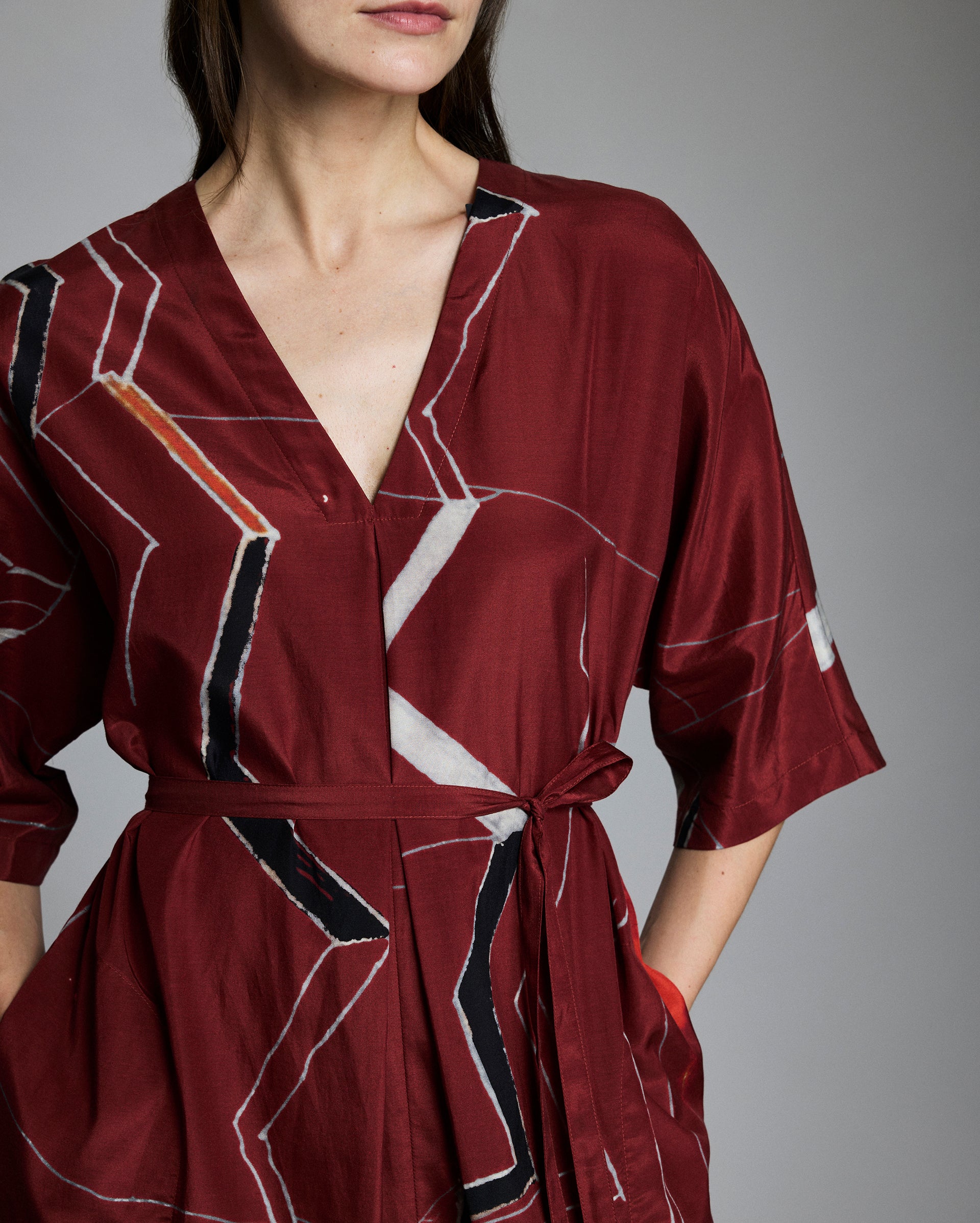 Close up of the dress, showing the tie belt and mountain-inspired print.