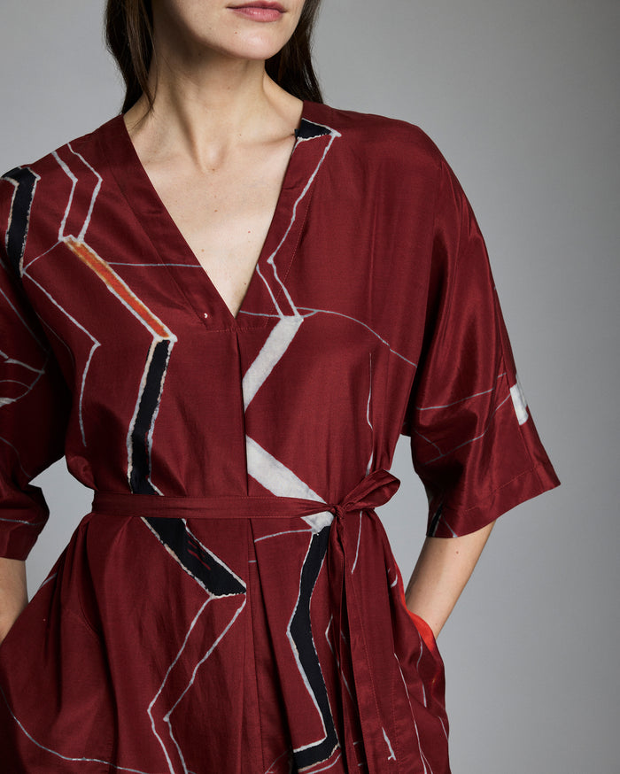 Close up of the dress, showing the tie belt and mountain-inspired print.