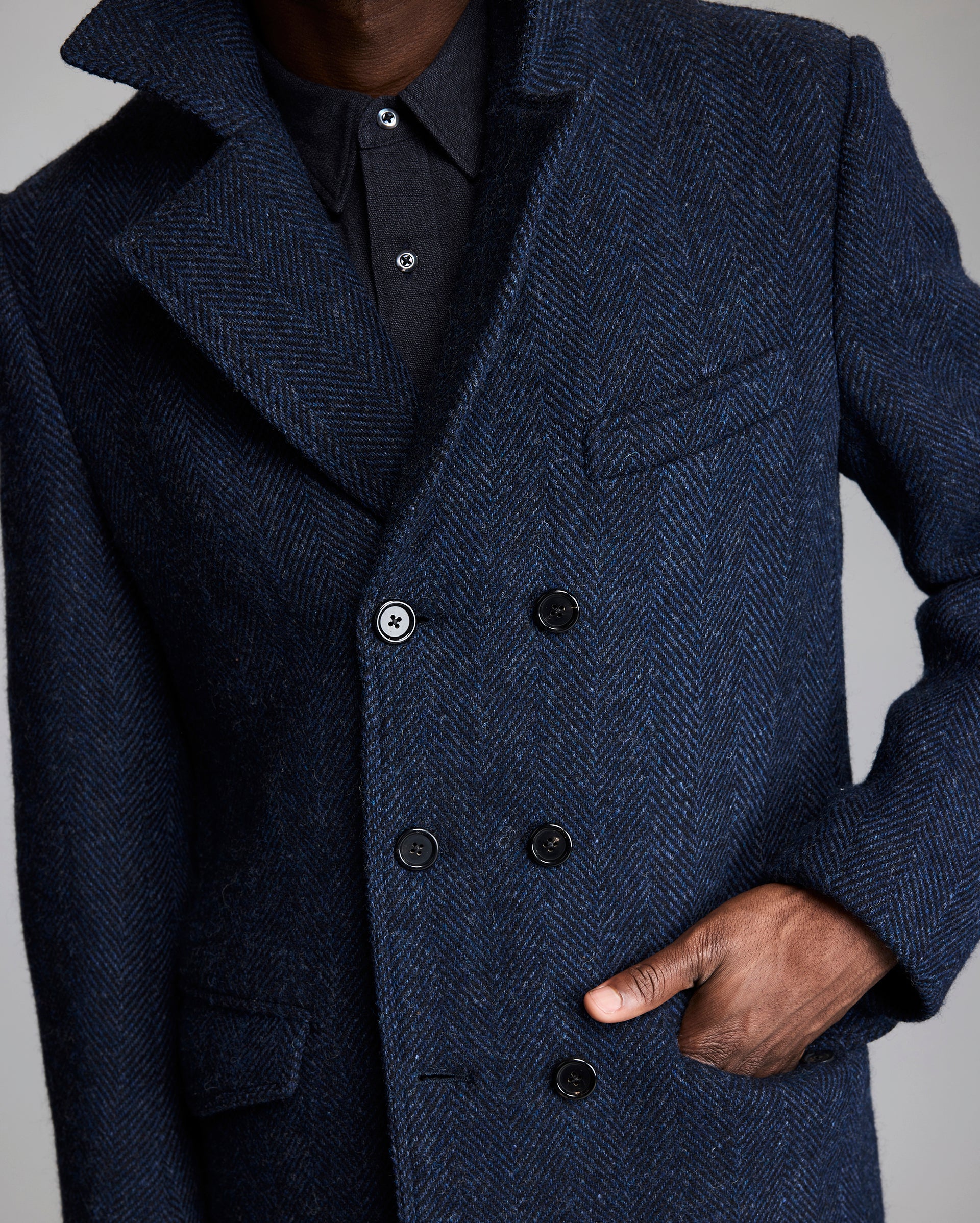 Model shows the pockets of the coat