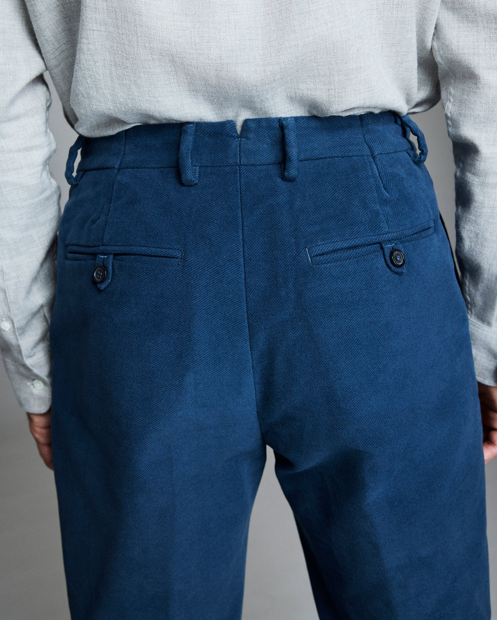 Back pockets, finished with dark horn button closures.
