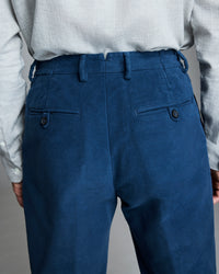 Back pockets, finished with dark horn button closures.