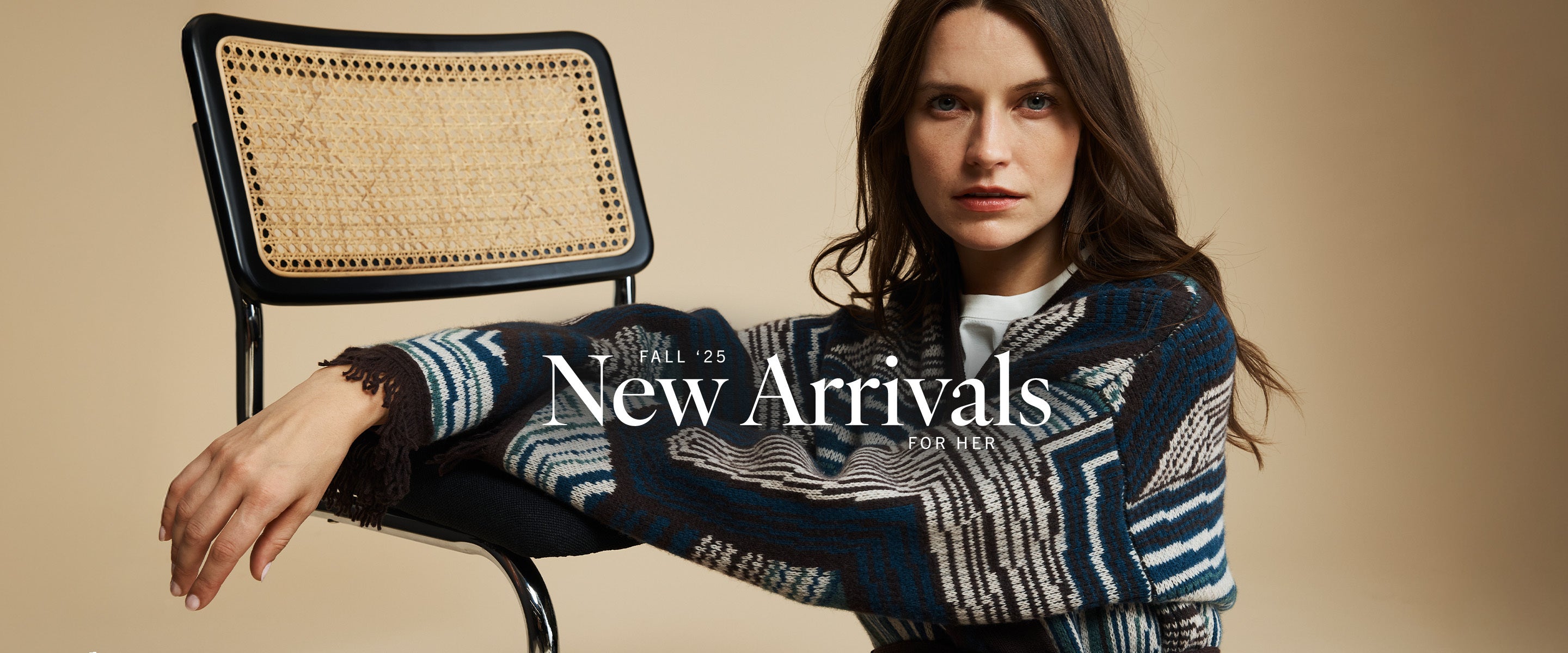Woman sitting on a chair wearing a patterned sweater with 'New Arrivals' text overlay.