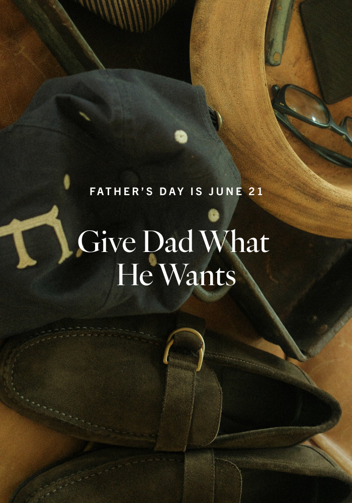 Dark brown leather shoes with a cap and wooden item on a dark background, Father's Day message overlay.