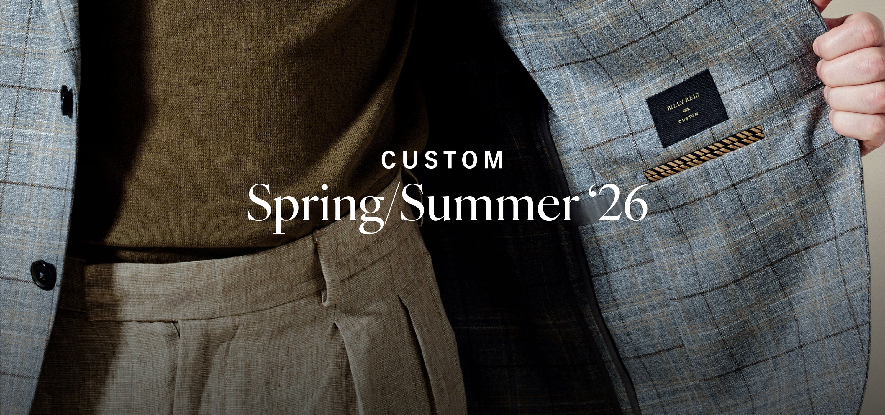 Gray suit with a visible brand label, featuring 'Custom Spring Summer '26' text.