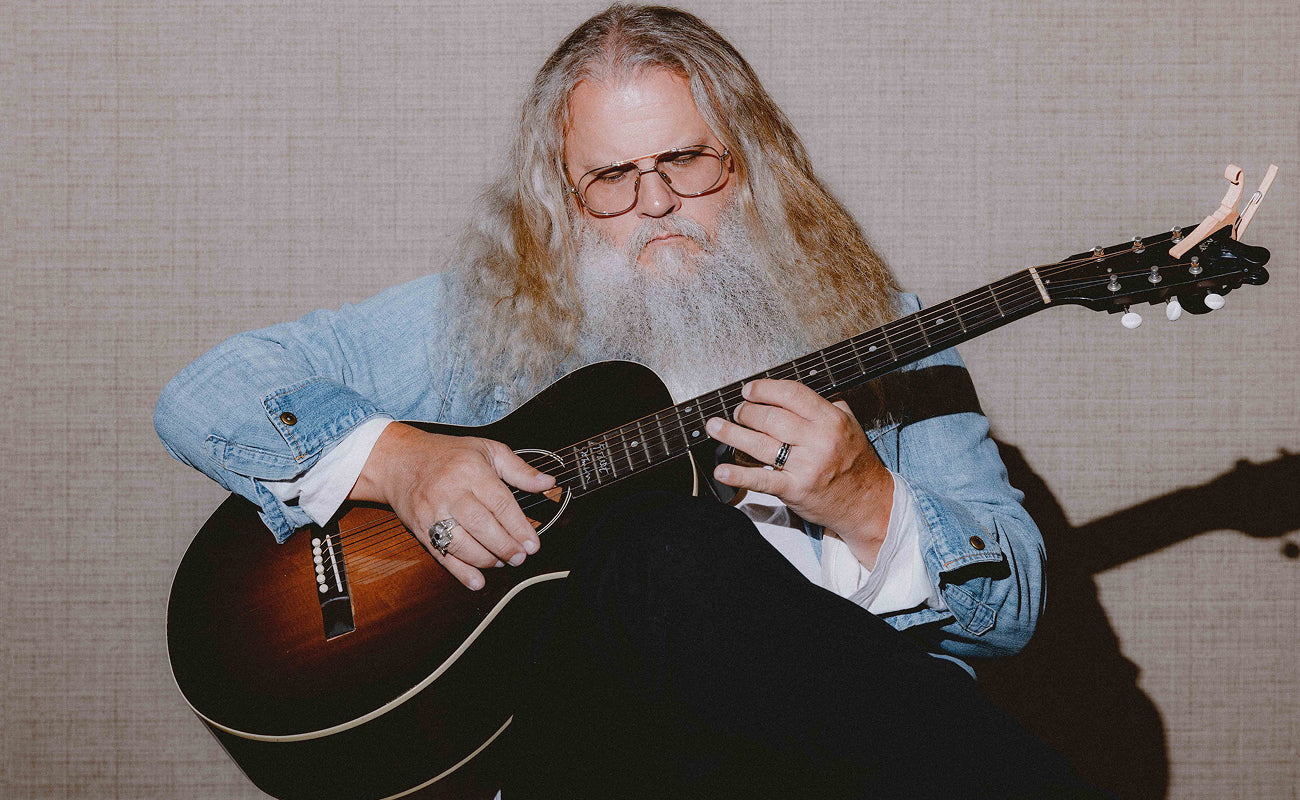 Jamey Johnson plays guitar while wearing Billy Reid.
