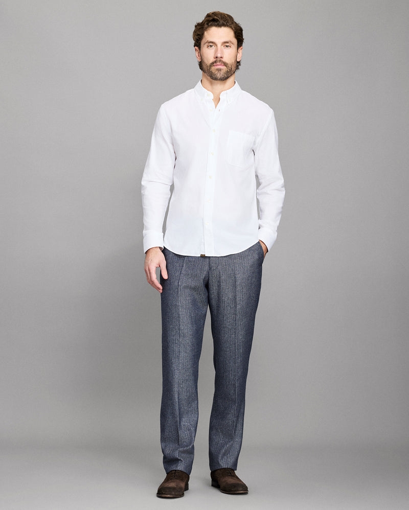 Man wearing a white shirt and gray pants on a gray background Alternate