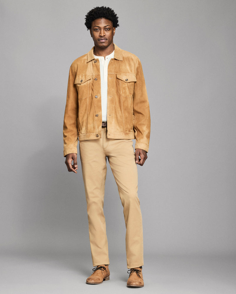 Man wearing a beige jacket and pants on a gray background Alternate