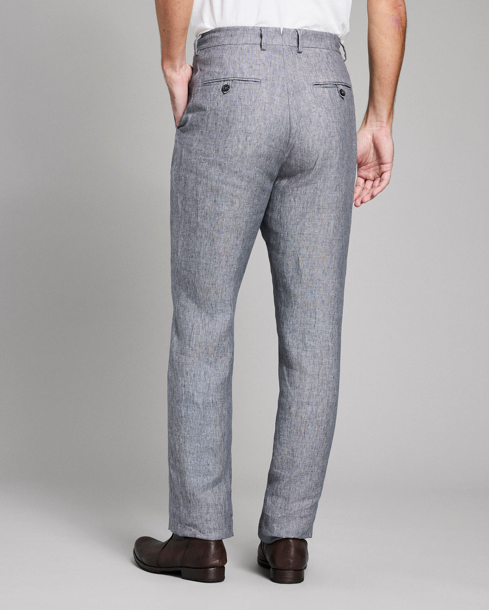 Gray checkered pants worn by a person on a plain background