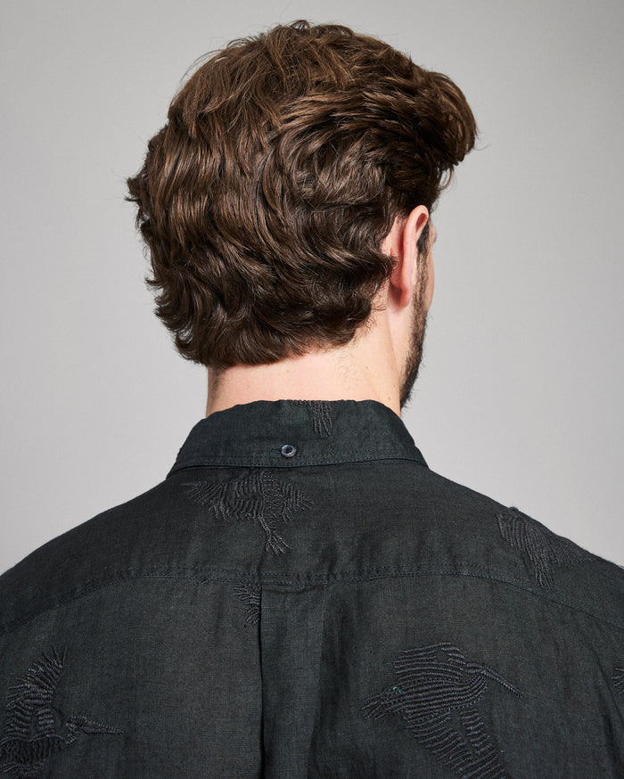Person wearing a black shirt with a gray background