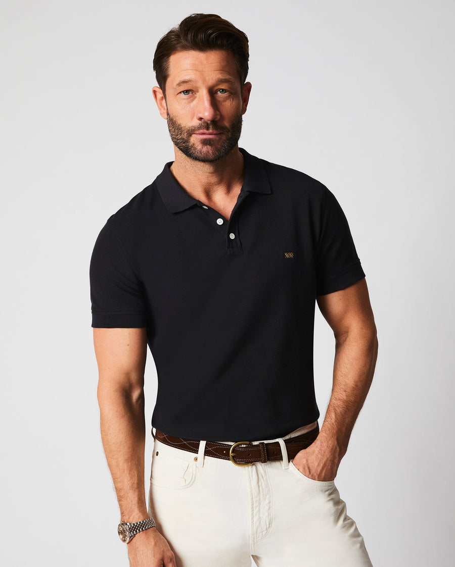 Male model wears the Pique Polo in Black