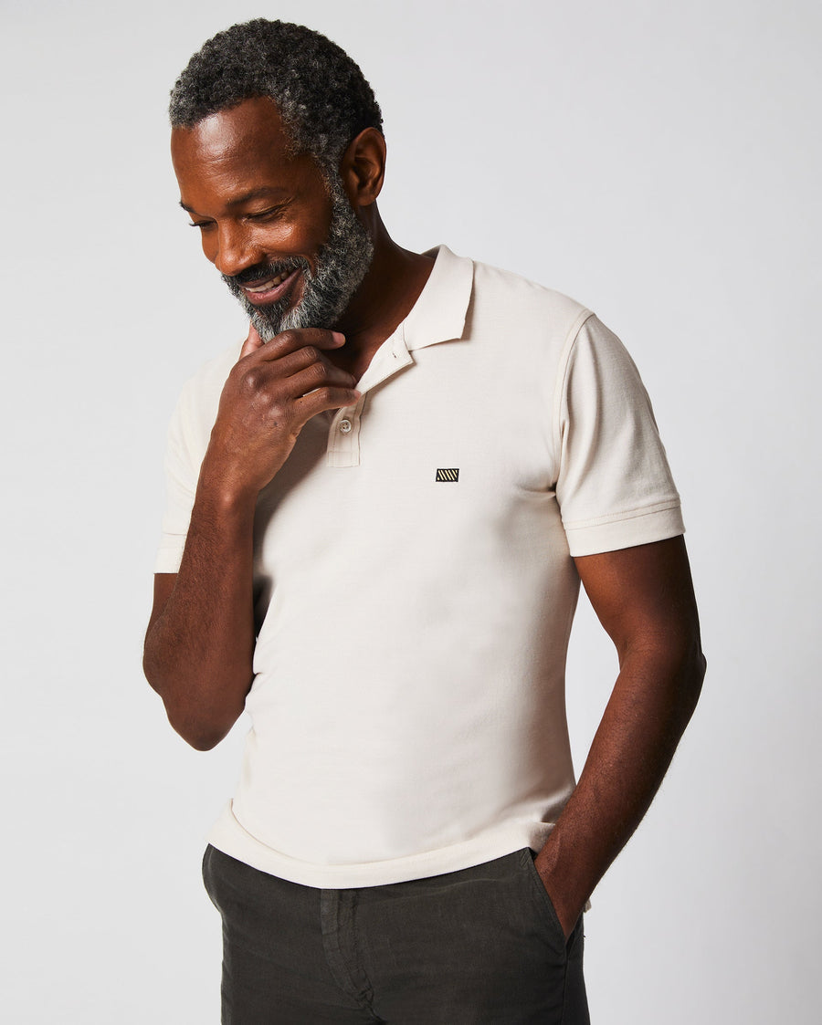 Male model wears the Pique Polo in Natural