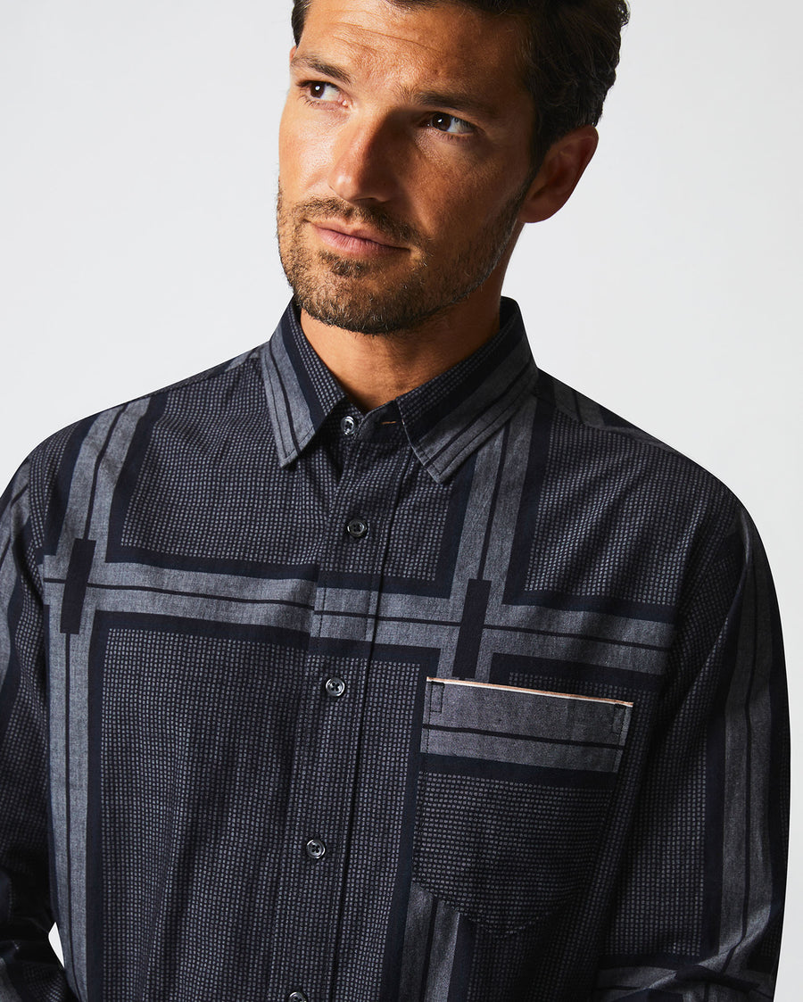 Male model wears the textured plaid MSL 1-Pocket shirt in black/dark brown
