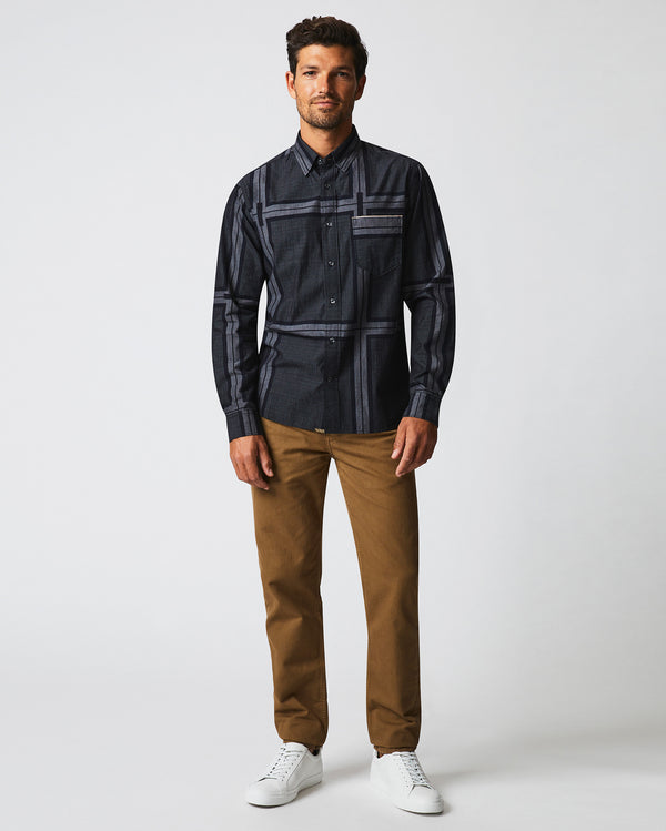 Male model wears the textured plaid MSL 1-Pocket shirt in black/dark brown