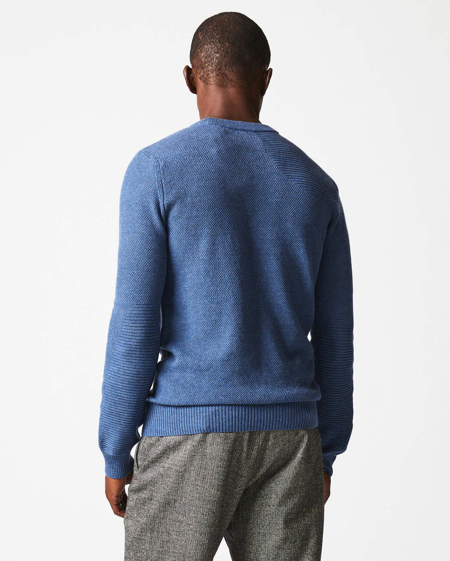 Male model wears the Hunting Sweater in Denim Blue