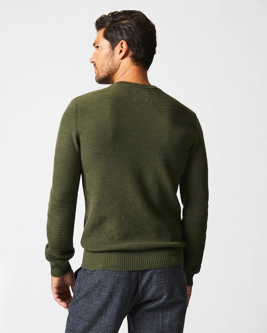 Male model wears the Hunting Sweater in Fern